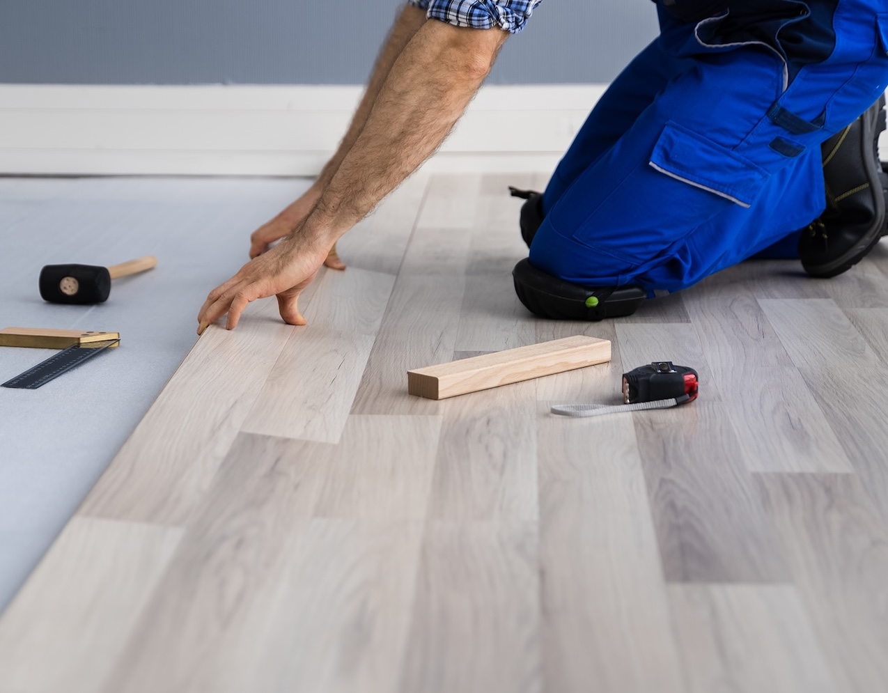 Hardwood,Floor,Renovation.,Construction,Worker,Doing,New,Laminate,Installation